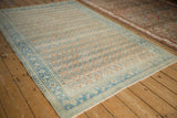 Vintage Hamadan rug with patterned lattice, pawn border, heavy abrashes, even wear in sand and blue.