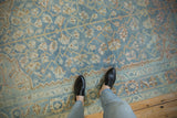 Distressed vintage Afshar rug with softened sky blue field and delicate floral palmette design.