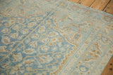 Distressed Afshar rug border with faded sky blue, pale coffee brown palmettes, geometric vines.