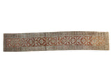 Distressed vintage Heriz rug runner with geometric palmettes in rust, terracotta, and faded powder blue.