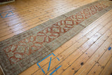 Full length perspective of a distressed Heriz runner showing the flow of its repeating pattern.