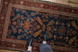 Cypress shrub and floral motifs on an antique Heriz runner showing mostly even wear to the knot heads.