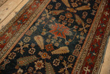 Low-pile texture of an antique Heriz runner showing cypress motifs against a navy blue field.