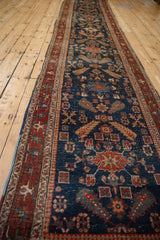 A perspective view showing the full length and repeating geometric pattern of the antique Heriz runner.