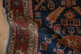 Antique Heriz runner corner showing wear to knot heads and restored polychromatic selvage edge.