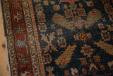 Close-up of cypress motifs and low pile on the navy field of an antique Persian Heriz runner.