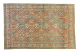 Vintage distressed Caucasian carpet with a repeating quatrefoil medallion trellis in cantaloupe and sky blue.