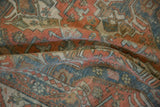 Soft folds revealing the hand-knotted texture and worn pile of a distressed vintage carpet.