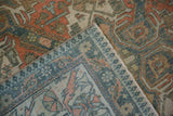 The hand-knotted foundation and secured side cord of a distressed vintage Caucasian carpet corner.