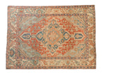 Vintage Baktiari rug with a distressed, stepped diamond medallion in reds, blues, and ivory.