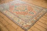 Angled view across the vintage Baktiari rug highlighting the texture and low, even pile.