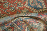 The pliable texture and low, even pile of a distressed Baktiari rug shown in a soft fold.