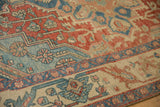 Evenly worn, hand-knotted texture on a vintage Persian rug with cherry red and sapphire blue motifs.