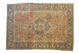 Antique Farahan Sarouk carpet with a scalloped center medallion on a rust field of blossoms and scrolled vines.