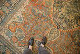 Low pile on an antique Farahan Sarouk showing even wear over terracotta and dusty blue florals.