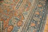 Intricate floral patterns and even wear on the low pile of an antique Farahan Sarouk carpet.