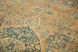 Close view of the antique Persian carpet's even wear, highlighting detailed floral and leaf-vein motifs.