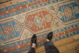 Antique Serab runner showing distressed texture, geometric medallions, and stylized animal motifs.