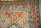 Detailed corner of an antique Serab rug with a stylized camel, sand field, and sky blue border.