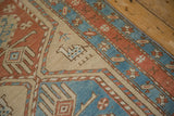 Stylized four-legged animal motif on the beige field of a distressed antique Serab rug runner.