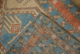 A folded corner of the antique Persian Serab rug revealing its hand-knotted weave and pile.