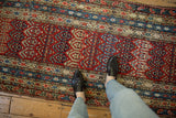 Overhead view of an antique Karabagh runner with a staggered boteh pattern and tiered borders.