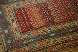 Detailed corner view of the antique Karabagh runner's multi-layered floral and vine borders.
