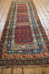 Long view of the antique Karabagh runner, emphasizing its geometric pattern and tiered borders.