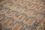Angled perspective on the geometric boteh and serpent motifs of the vintage Afshar rug pile.