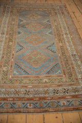 Angled perspective of a vintage Malayer rug runner highlighting its geometric pattern flow.