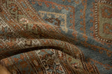 Soft, draping folds reveal the short pile and abrashed colors of a vintage Malayer rug.