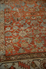 Vintage distressed Bijar runner's Herati field with terracotta and blue abrashes.