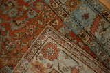 Terracotta and powder blue worn Herati pattern on a vintage Bijar rug corner.