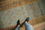 Distressed boteh field and geometric arabesque border on a vintage Persian Afshar runner.