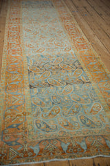 Long perspective view of the vintage Afshar runner showing its heavily abrashed color and boteh pattern.