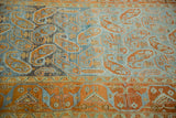 Angled detail of a vintage Afshar runner showing the distressed, low pile with terracotta boteh designs.