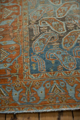 Detail of a vintage Afshar rug's arabesque border and botehs in terracotta and blue.