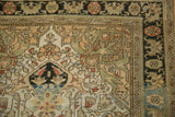 Charcoal floral border and intricate guard bands on a distressed vintage Persian Sarouk rug corner.