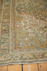 Even wear to the knot heads and dusty teal border on a vintage distressed Sarouk rug.