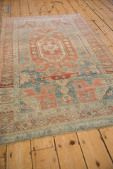 Angled view of a distressed Bijar rug highlighting its even wear and straight, machine-bound edge.