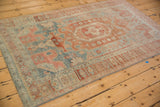 The abrashed field and even wear of a vintage Persian Bijar rug in dusty blue and pomegranate red.