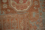 Close-up showing the hand-knotted back and machine-bound edge of a vintage Bijar rug.