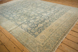 Corner detail of a distressed Bijar carpet showing the dramatic color shift from heavy abrash.