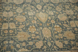 Distressed texture of a vintage Bijar carpet with dusty navy and sand floral patterns.