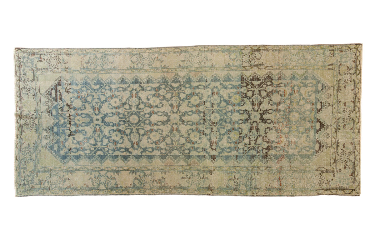 Distressed vintage Mahal runner, faded blue Herati diamond pattern, meandering vine borders.