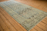 Distressed Mahal runner corner, showing faded Herati pattern, meandering vine border, and visible foundation.