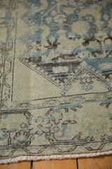 Distressed Mahal runner's worn pile texture with faded blue-green Herati pattern and fringe.