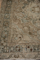 Vintage Karaja rug pile, showing mostly even wear and time-softened beige geometric blossoms.