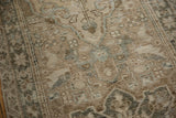 Distressed Karaja runner texture showcasing pale sand and oxidized silver geometric patterns.