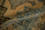 Softly folded Senneh rug showing the low pile and dusty blue details of the Samovar main border.